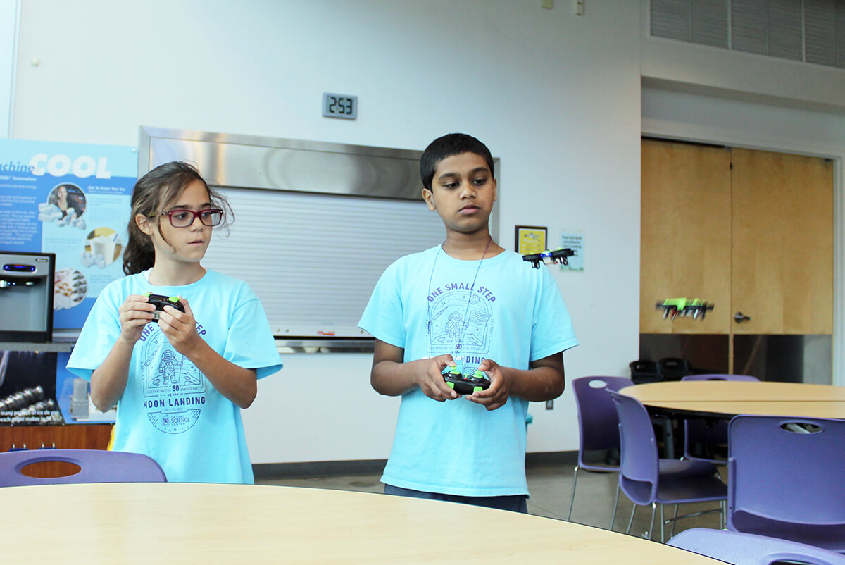 Two students using drones