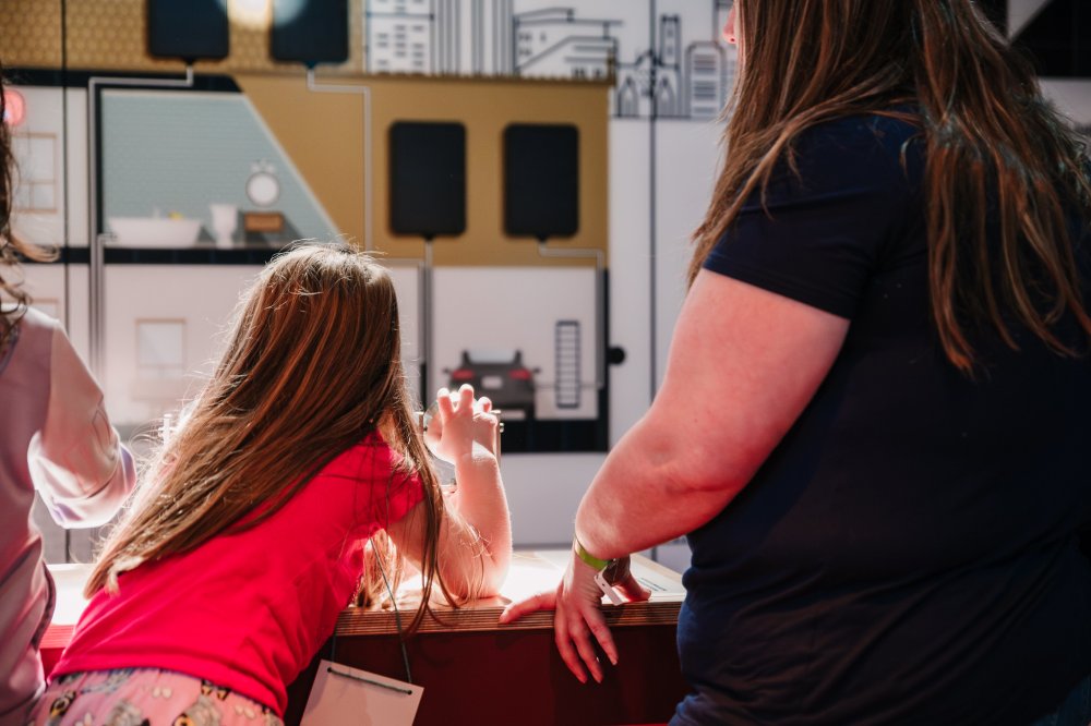 Photo of a child using the solar panel exhibit