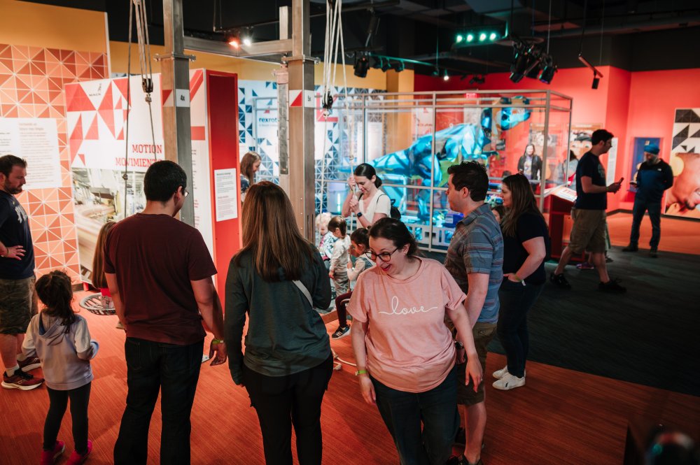 Photo of families exploring the Science in the Making exhibit gallery