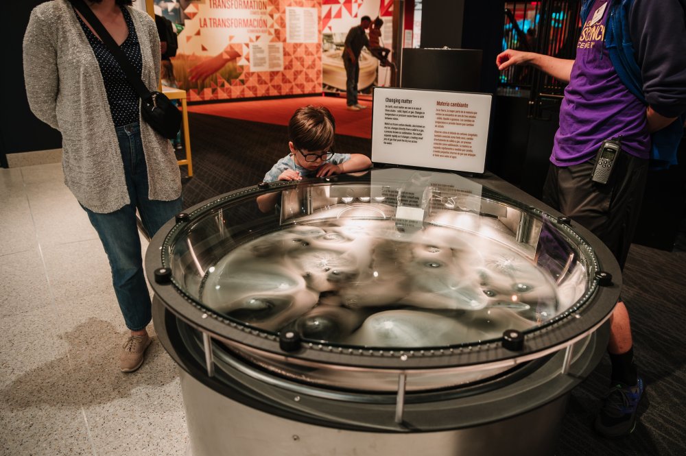 Photo of a child captivated by the "Changing Matter" exhibit