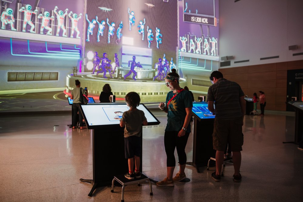 Photo of families enjoying the interactive Curiosity Hall exhibit